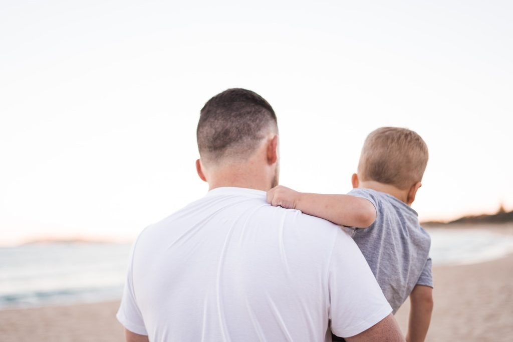 from behind, A Man with child in his arms